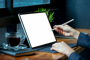 Fototapeta na wymiar Businesswoman working on blank screen modern tablet in office.