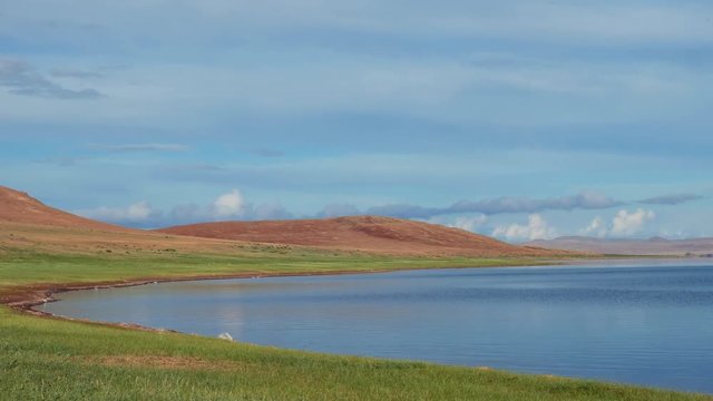 Calm waters of mongolian lake Telmen Lake surrounded by hills and deserts in north Mongolia