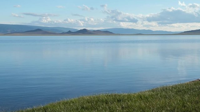 Calm waters of mongolian lake Telmen Lake surrounded by hills and deserts in north Mongolia