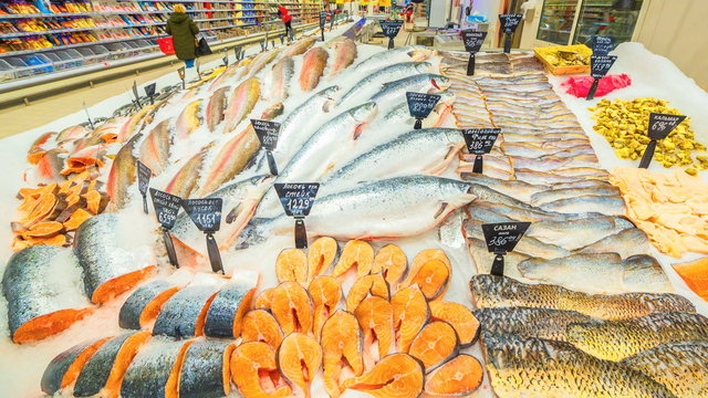 A Large Selection Of Fresh Fish Lying In The Ice On The Counter Of The Supermarket. 