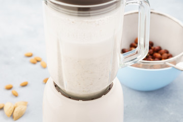Homemade nut milk in blender and ingredients.