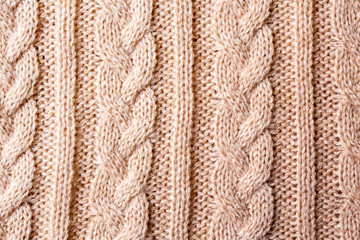 冬物衣類　ベージュピンクの縄編みニットのテクスチャ　パターン