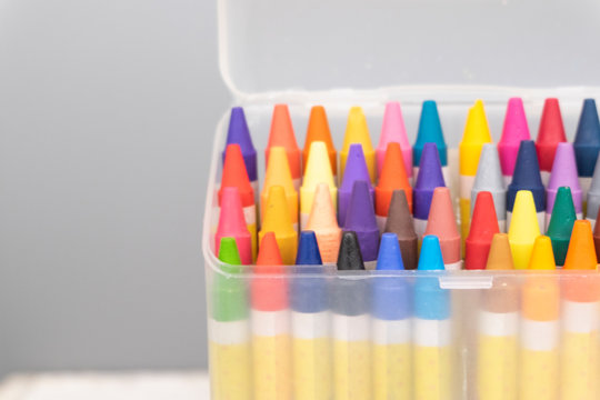 education and back to school concept, colorful crayons in the transparent box.selective focus shot and grain effect