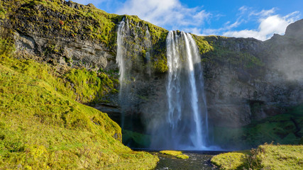 Beautiful Seljalandsfoss one of famous waterfall in Iceland and sunny day and blue sky in summer.