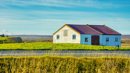 Beautiful rural view traditional house and farm field at small village in Svalbardseyri near Akureyri, Iceland