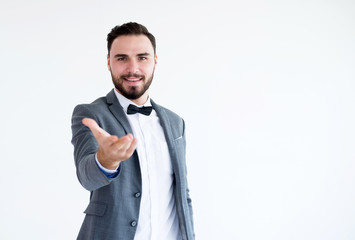 Man in formal suit standing and shows gesture outstretched hand open palm on white background with copy space for text,Happy and smiling
