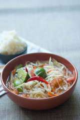 Somtum or papaya salad with red hot chili and Thai herb sauce