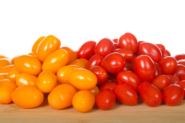 Zima, an orange grape tomatoes next to Angel Sweet grape Tomatoes. Both great for salads or snacking.