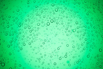 Rain droplets on green glass background, Water drops on glass.