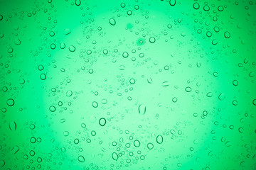Rain droplets on green glass background, Water drops on glass.