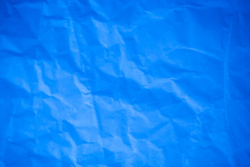 Crumpled blue paper background.