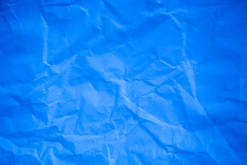 Obraz premium Crumpled blue paper background.