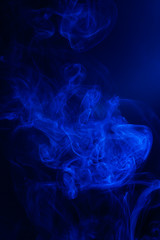 Blue smoke on black background.