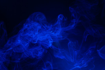 Blue smoke on black background.