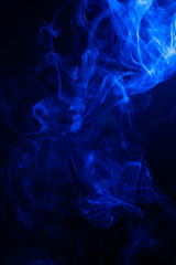 Blue smoke on black background.