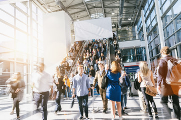 Crowd of anonymous people walking, with copy space banner