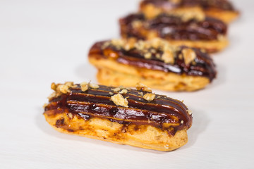 Food, desserts and bakery concept - Traditional French dessert eclairs with chocolate and nuts