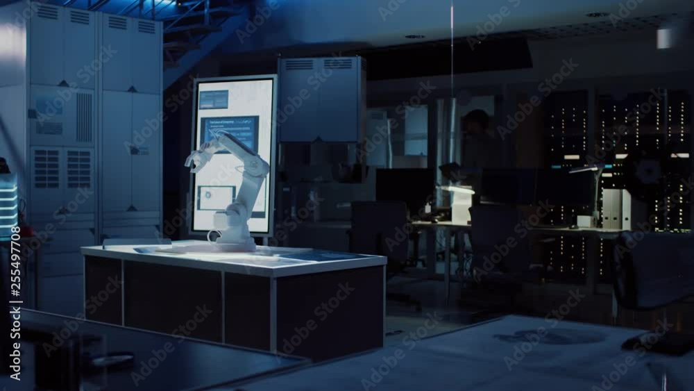 Leinwandbilder In Industrial Robot Desing Research Laboratory: Robotic Arm Prototype Standing Illuminated on the Desk. In the Dark Background Various High Tech Devices, Computers, Digital Whiteboard and Blueprints