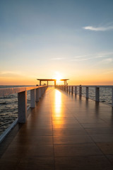 Fototapeta na wymiar Landscape of bridge in sea on tropical beach and sunset sky background .