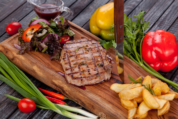 juicy and appetizing steak tamogavok of horse meat on the table, for design in cooking	