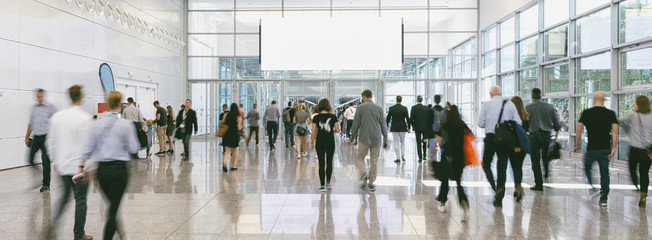 large Crowd of anonymous business people walking, with copy space banner