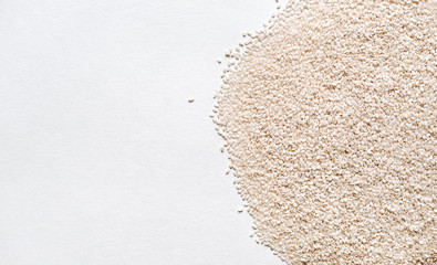 Texture of scattered white sesame seeds. Background, closeup, copy space.