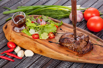 juicy and appetizing steak tamogavok of horse meat on the table, for design in cooking	