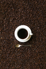 Coffee cup on coffee bean background still life image.