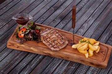 juicy and appetizing steak tamogavok of horse meat on the table, for design in cooking	