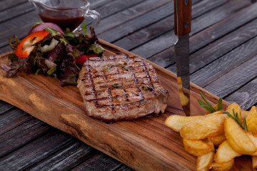 juicy and appetizing steak tamogavok of horse meat on the table, for design in cooking	