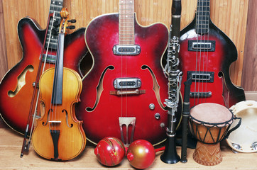 Fototapeta na wymiar Three electric guitars, violin, maracas, djembe