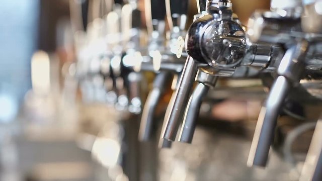 Shining beertaps in craft brewery, draft beverage for real lovers, sport pub