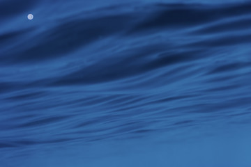 Underwater photograph of abstract ripples on sea surface.