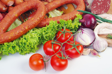 Meat products, sausage, ham, decorated with vegetables and spices on the table