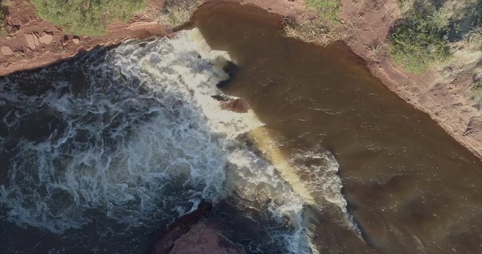 waterfalls and rapids on a stream at Colorado foothills, ascent aerial shot