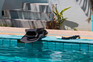 flippers and snorkel on the edge of the pool
