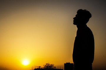 silhouette of a man in sunset in bareilly city, boy portrait 