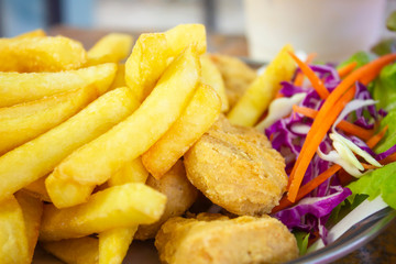 French fries and Nuggets meal on wood table,  junk food and unhealthy food