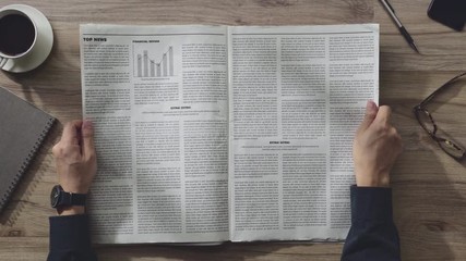Business man reading the Newspaper on wooden table in the room on the morning, Daily Newspaper mock-up concept - Powered by Adobe