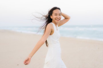 Fototapeta na wymiar Portrait beautiful young asian woman happy and smile on the beach sea and ocean