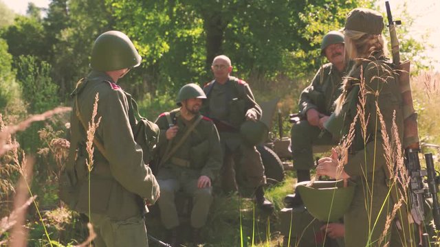 Soldier in camp standing up and talking