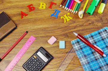 Getting ready for school. School stationery on a wooden table. 