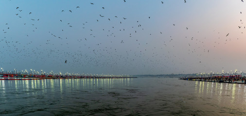 Kumbha Mela, Allahabad, Uttar Pradesh, India; 17-Feb-2019; lights on the river banks, sunset at Sangam, river Ganges