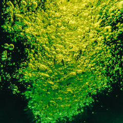 Green background bubbles water. close up.