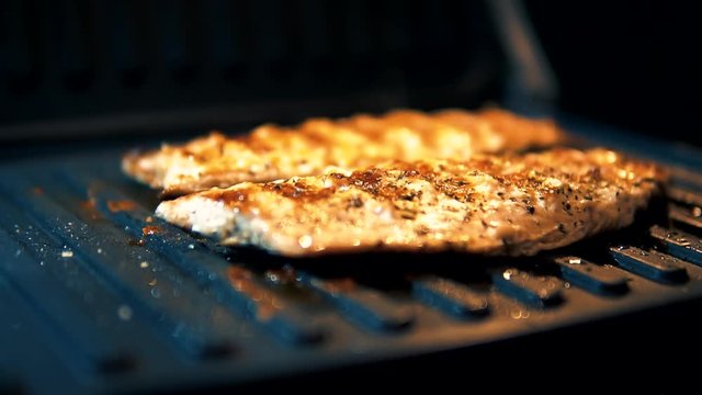 Chef Seasoning Spice Mackerel Fish.Slow Motion Seasoning Fried Fish On Barbecue.Man Sprinkling Spices Over Fried Fish Fillet On Barbecue.Fried Scomber Fish With Spices.Fish Lying On Grill Barbecue.