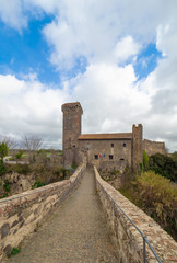 Fototapeta na wymiar Vulci (Italy) - The medieval castle of Vulci, now museum, with Devil's bridge. Vulci is an etruscan ruins city in Lazio region, on the Fiora river between Montalto di Castro and Canino.