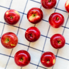 Fresh raw red apples on cloth, overhead view. Flat lay, from above, top view.