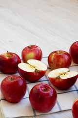 Fresh raw red apples on white wooden surface, low angle view. Close-up. Copy space.