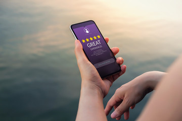 Customer Experiences Concept. Five Stars Rating and Positive Review show on Smartphone's Screen....