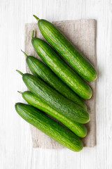 Raw green cucumbers, overhead view. Flat lay, top view, from above. Close-up.